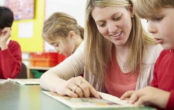 Teacher and student using a decodable reader